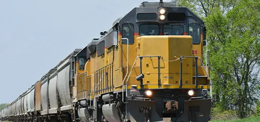 freight train pulled by yellow locomotive