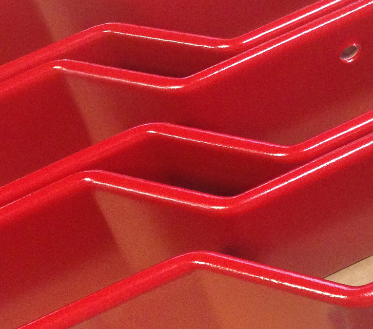 nested angled parts coated in red